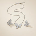 Chopard Happy Diamonds Butterfly Necklace & Earrings Set — White-Tone Metal with Pavé-Set Stones and Heart-Shaped Floating Diamond Details.