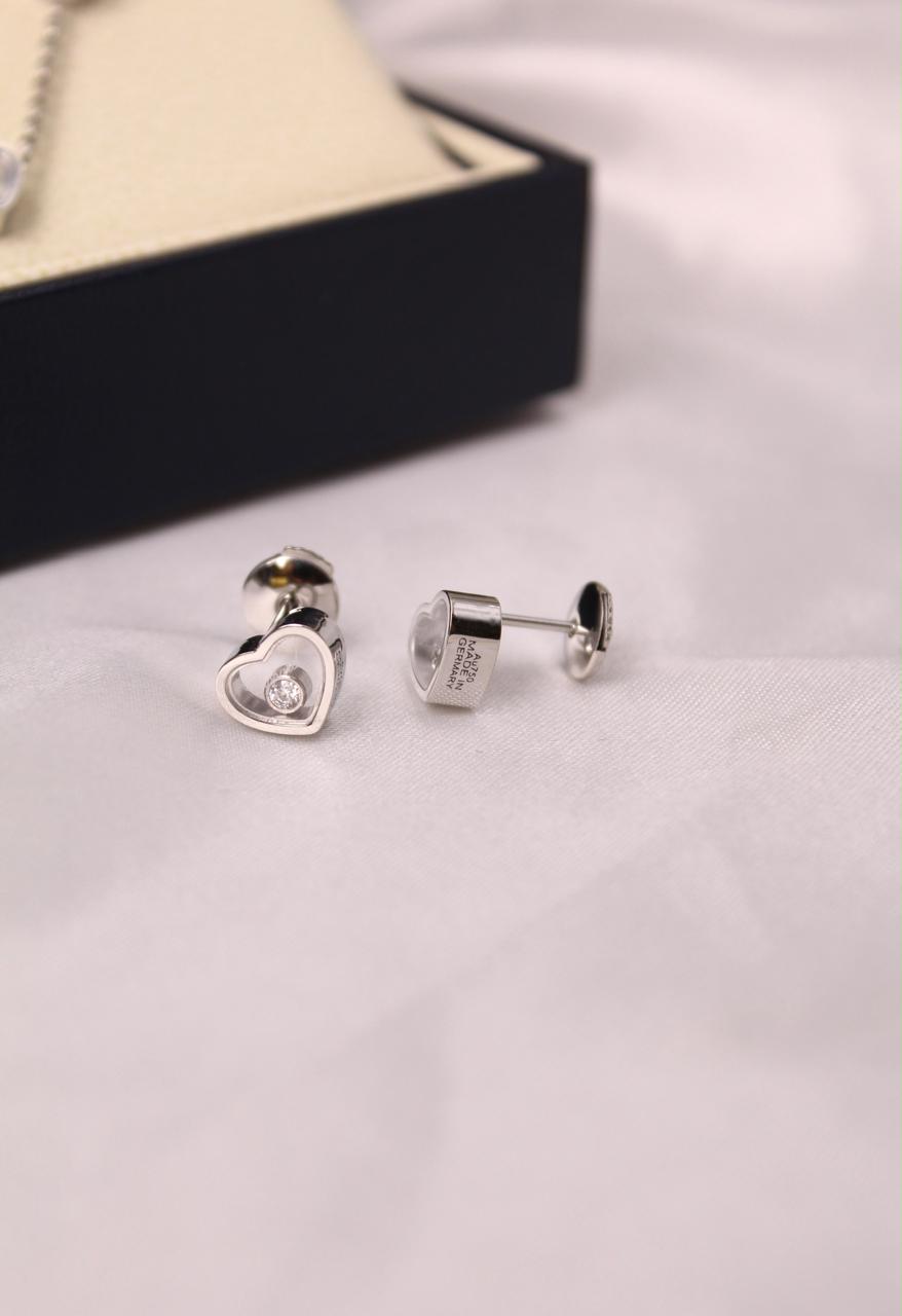 Chopard Happy Diamonds Happy Hearts Stud Earrings —  Heart-Shaped Design with Floating Diamonds.