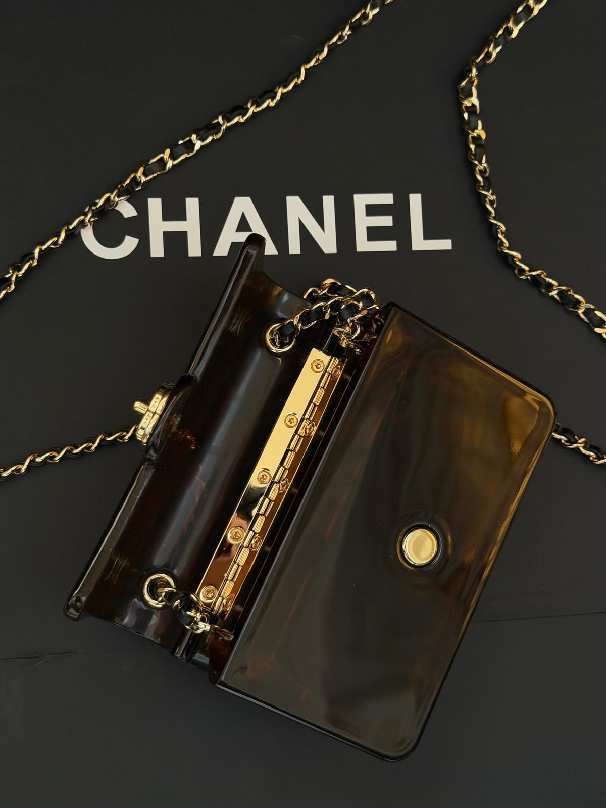 Chanel Mini Evening Bag
Tortoiseshell-patterned plexiglass body and gold-tone chain strap