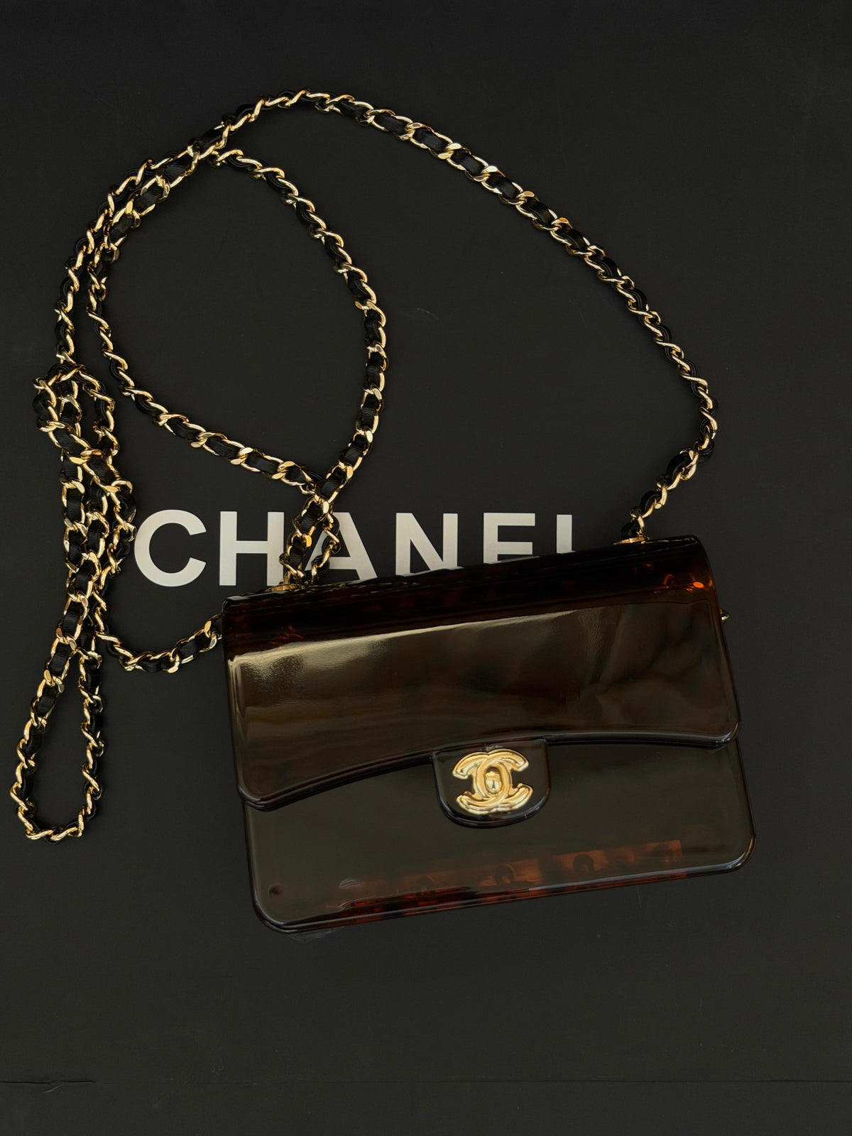 Chanel Mini Evening Bag
Tortoiseshell-patterned plexiglass body and gold-tone chain strap