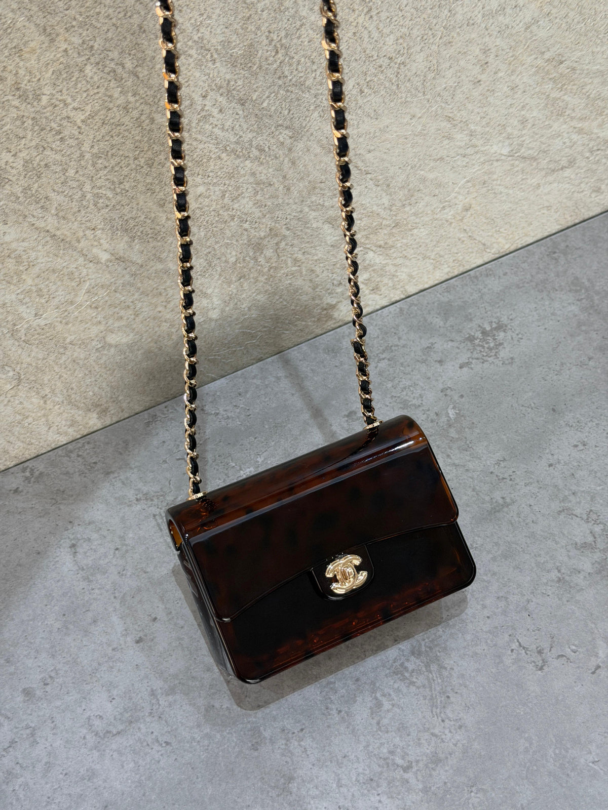 Chanel Mini Evening Bag
Tortoiseshell-patterned plexiglass body and gold-tone chain strap