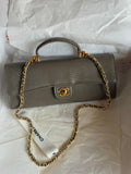 Chanel Clutch with Top Handle in lizard-embossed calfskin