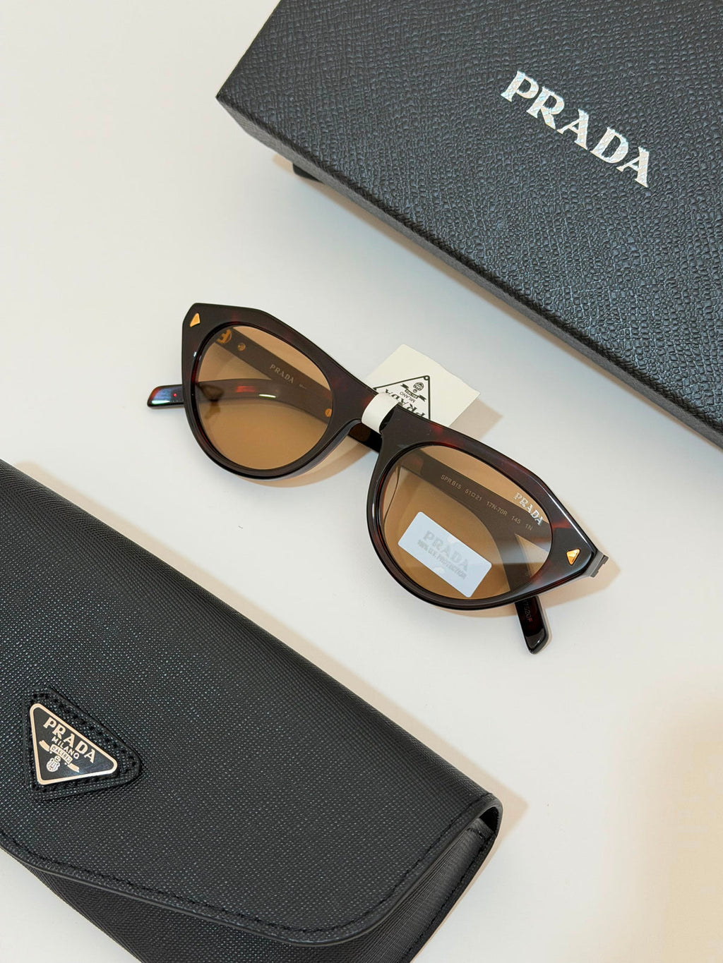 Prada Iconic metal plaque sunglasses for Women